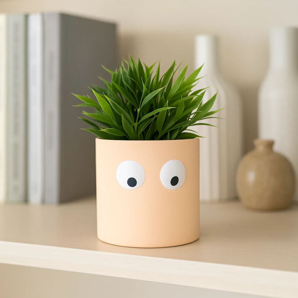 Face of Green Ceramic Planter With Playful Eye Design