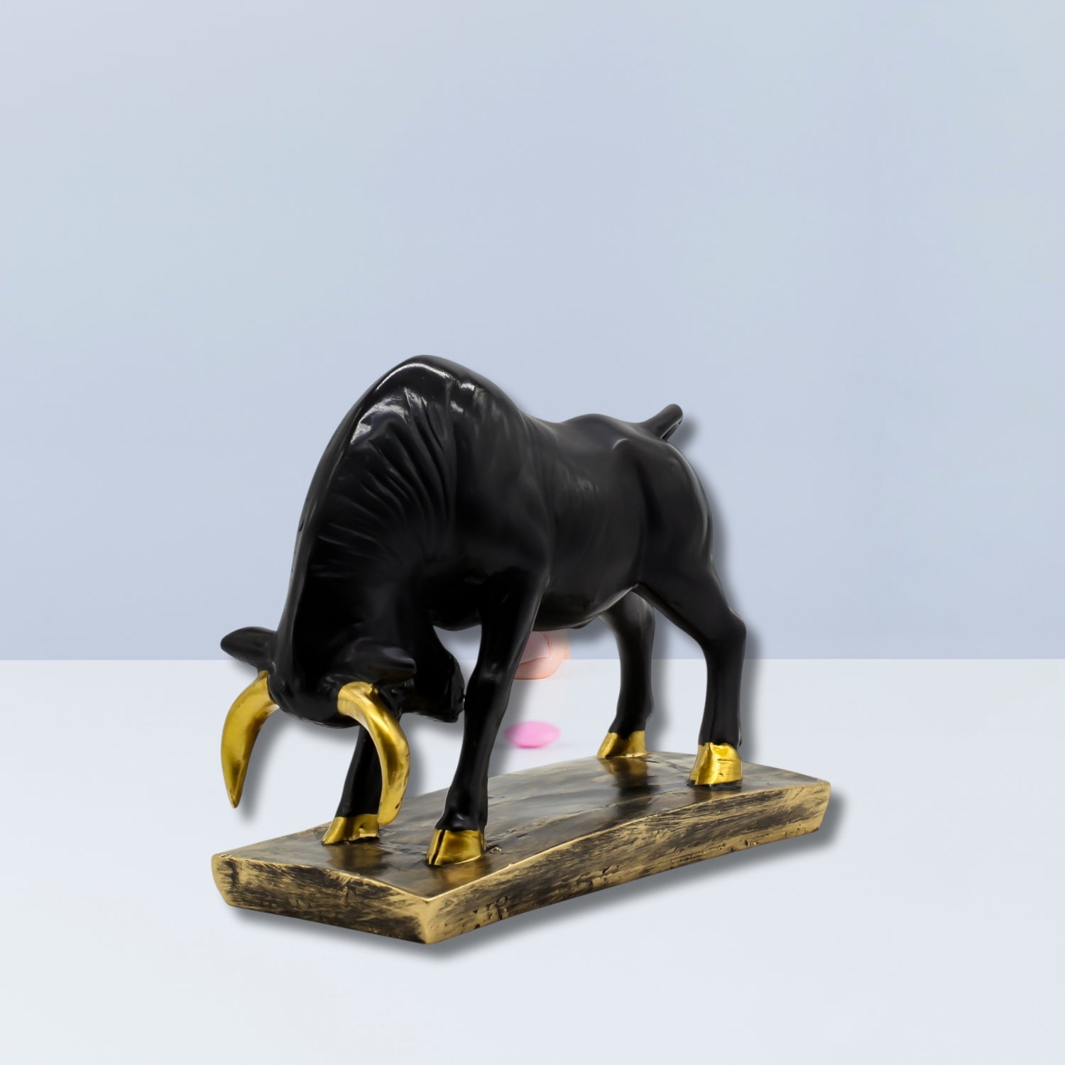 Elegant Black Bull Statue With Gold Accents on Luxurious Display Base